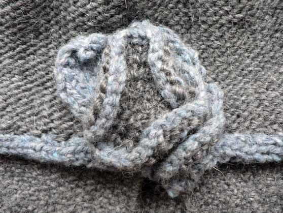 Close-up of knitted flower on cloche hat