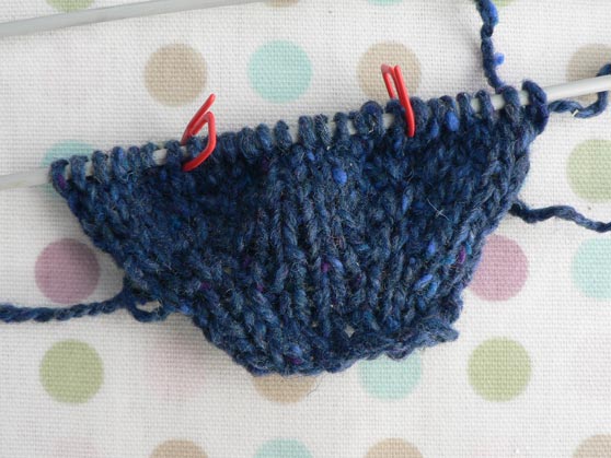 Sample of knitting to show raglan increases using knitting in front and back of stitch on either side of marker